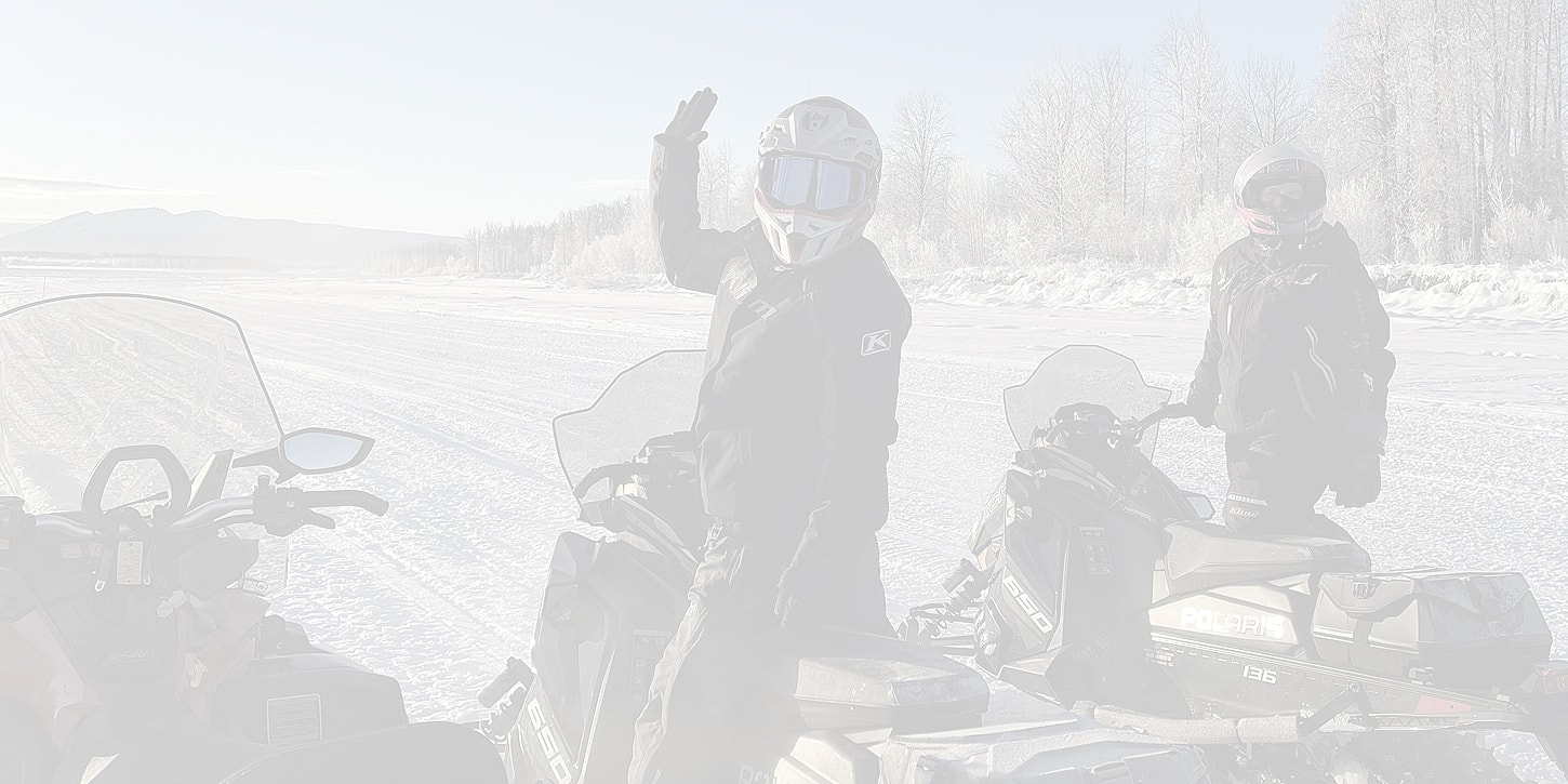Snowmobilers enjoying a winter day outdoors.