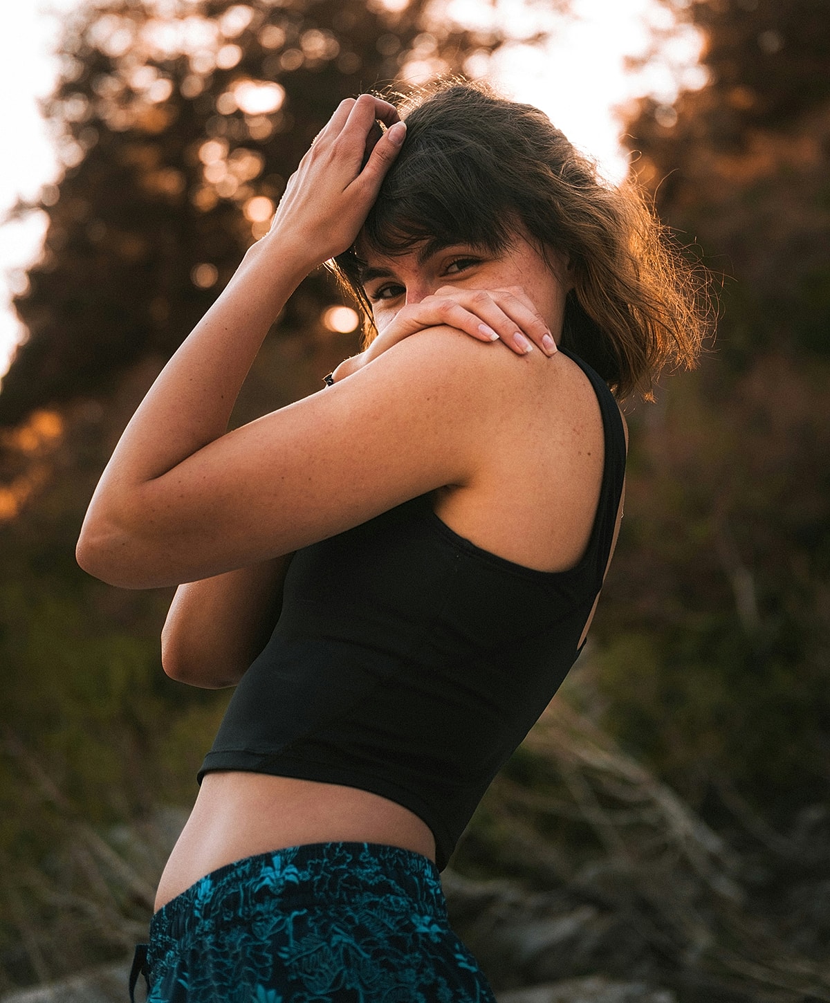 Woman posing outdoors during sunset.