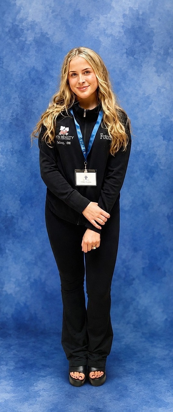 Smiling young woman in black attire.