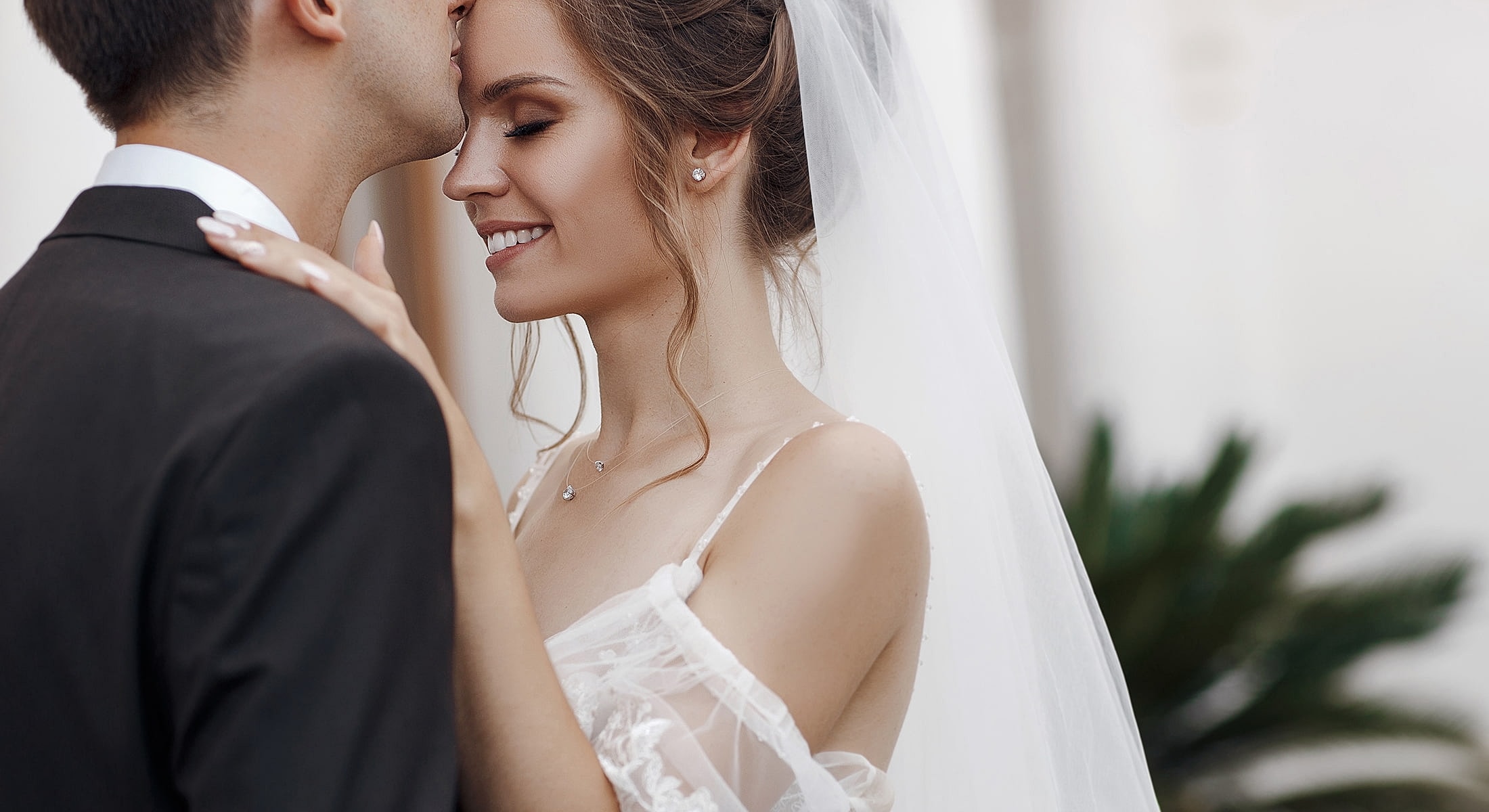 Woman sitting wrapped in white sheets.